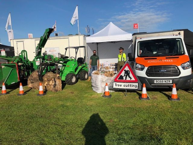 A ford van is parked next to a sign that says tree cutting