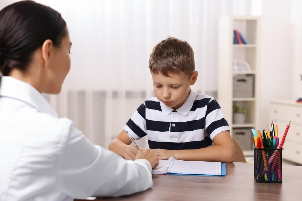 A Boy Is Sitting and Talking to A Doctor — Oracle Psychology Child & Adolescent Psychologists Newcastle in Newcastle, NSW