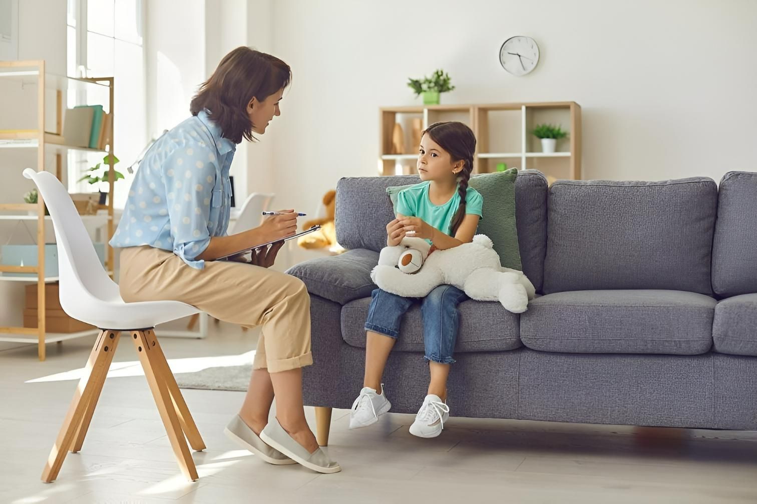 A Woman Sitting on A Couch Talking to A Girl — Oracle Psychology Child & Adolescent Psychologists Newcastle in Newcastle, NSW