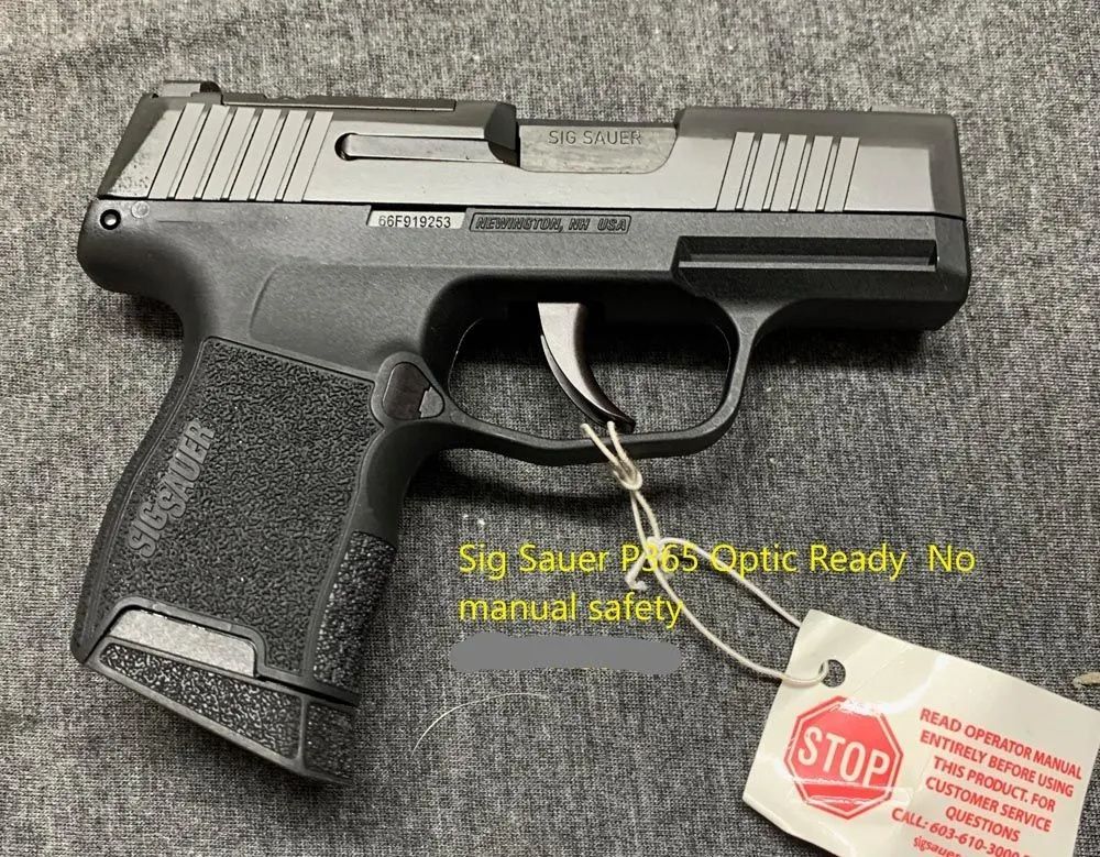 A sig sauer pistol is sitting on a table with a tag attached to it.