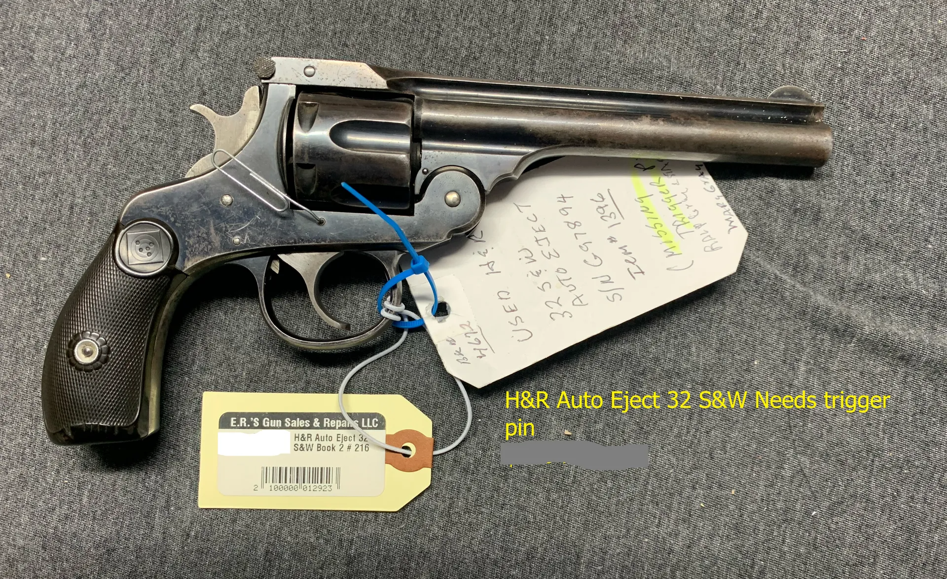 A black revolver with a tag attached to it