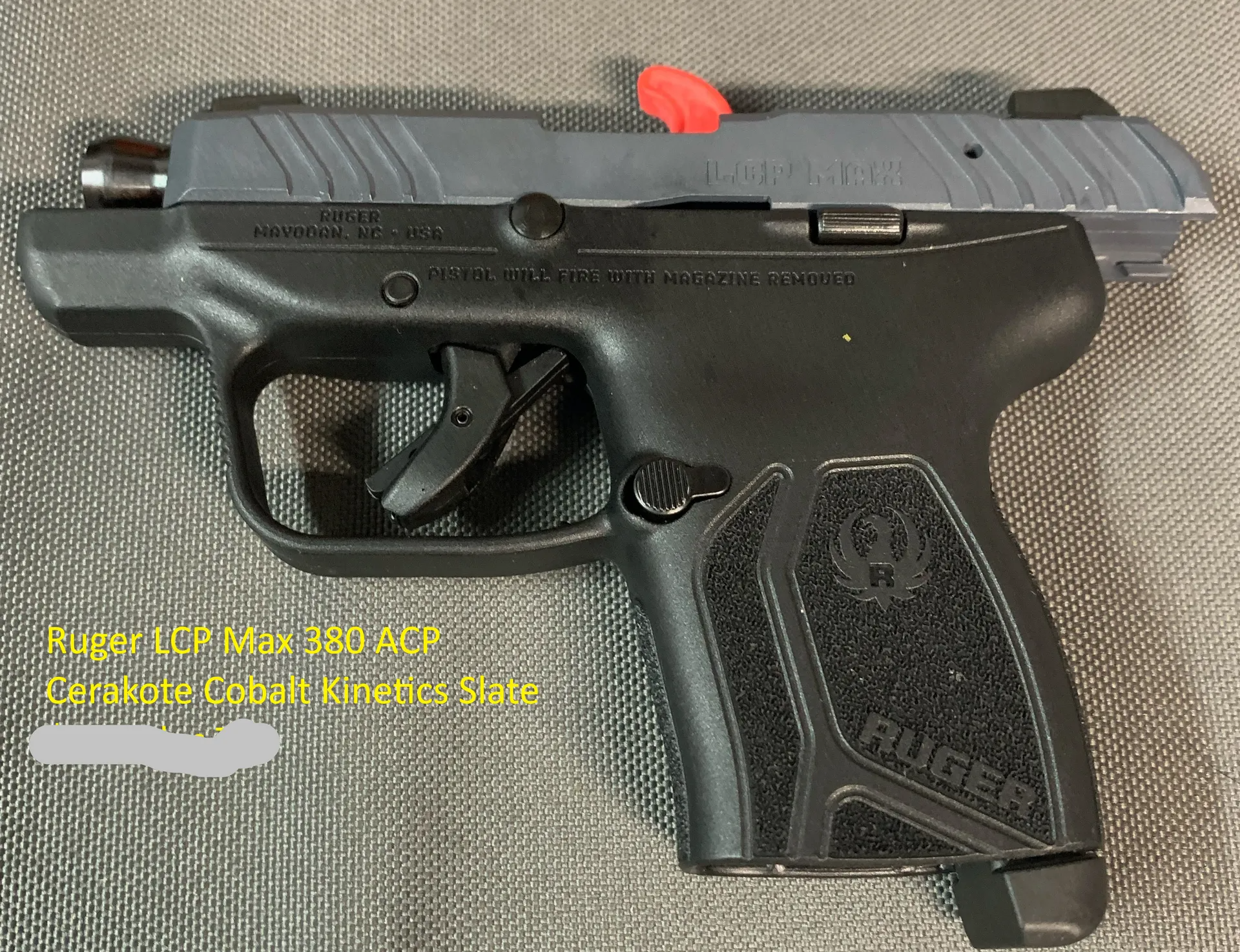 A black ruger pistol is sitting on a table