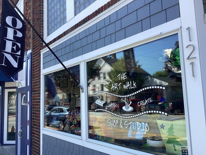 A store front with a sign that says open on it.