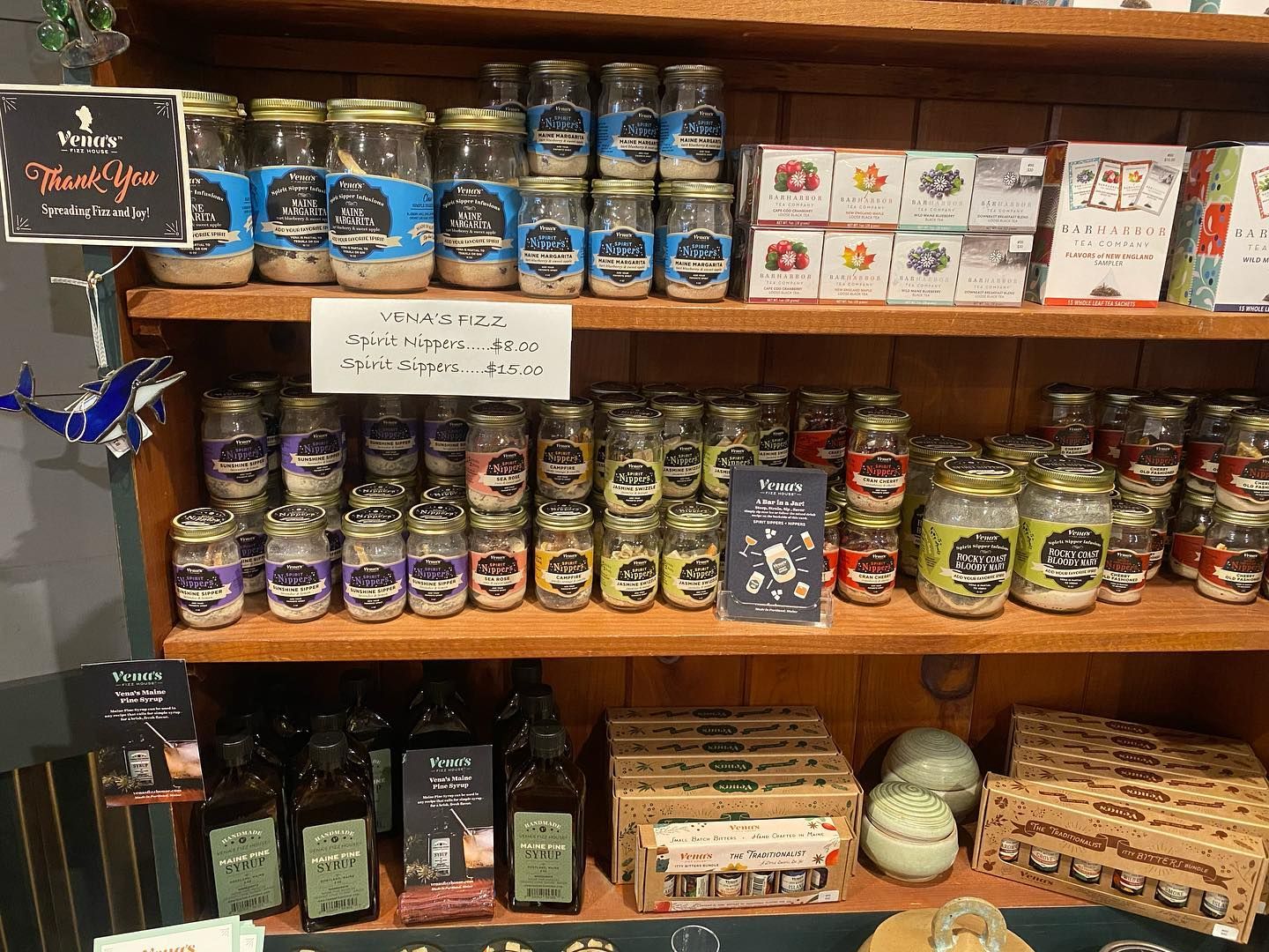 A shelf filled with jars of food and a sign that says thank you