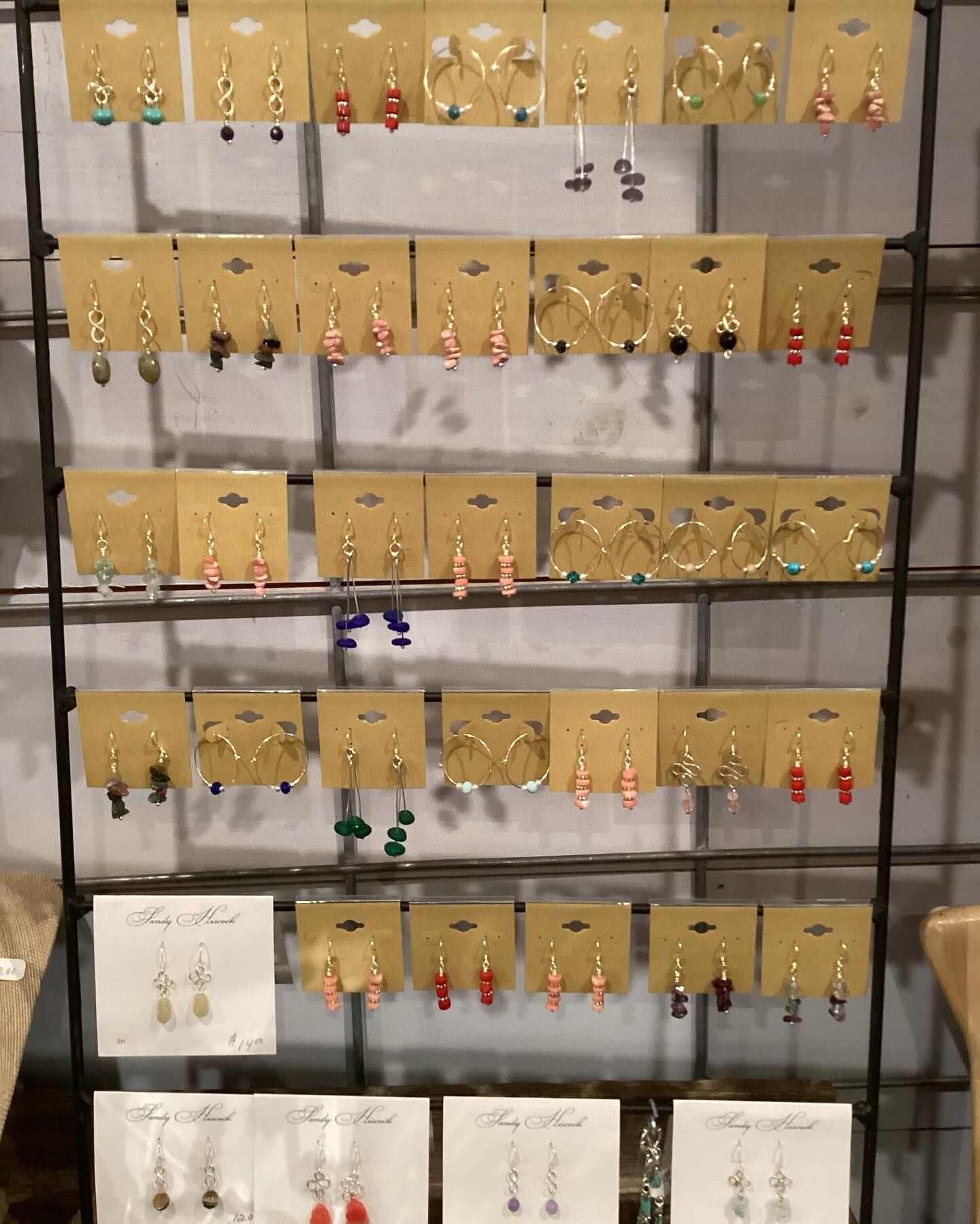 A display of earrings on cards on a rack in a store.