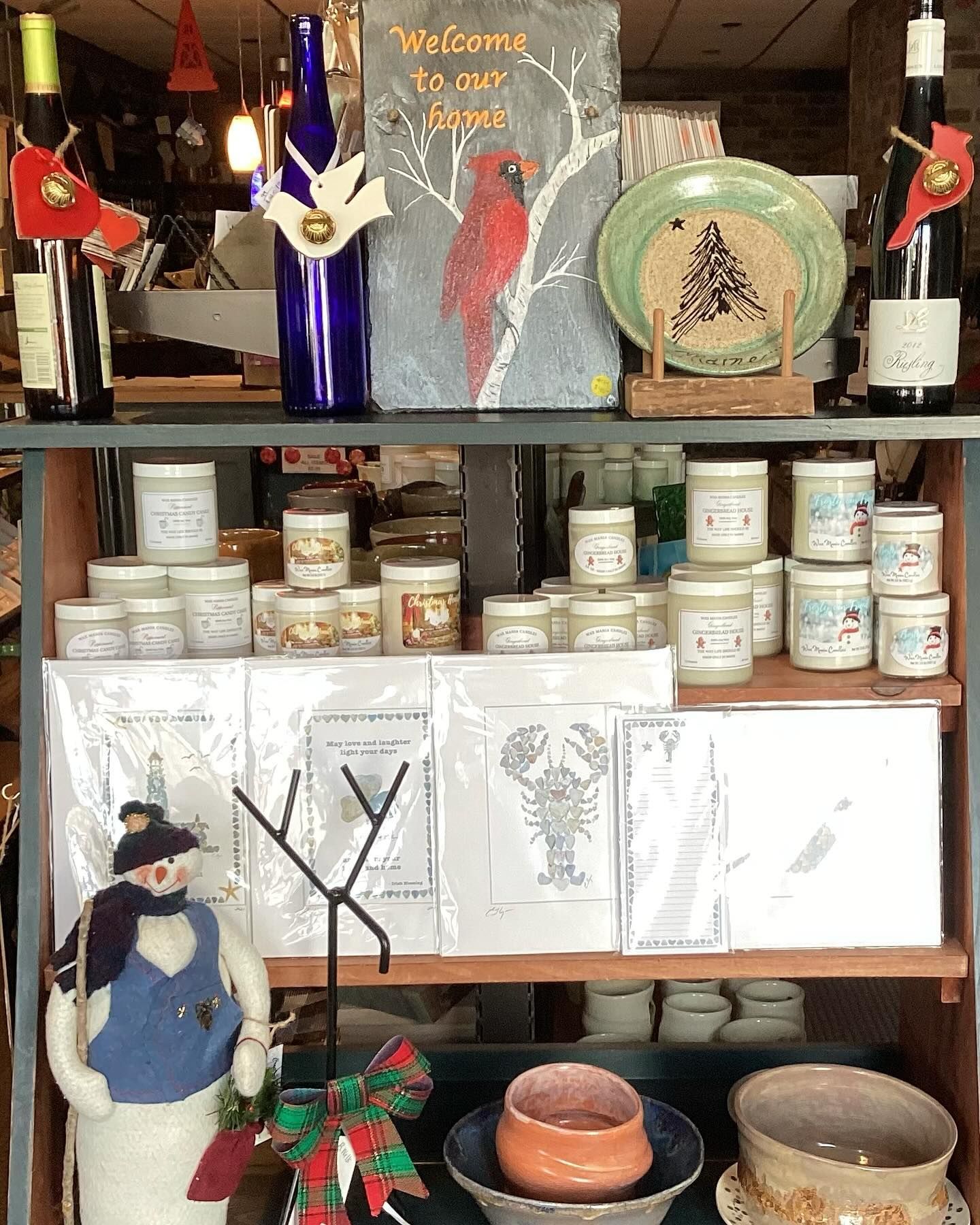 A shelf with candles and a sign that says welcome to our home