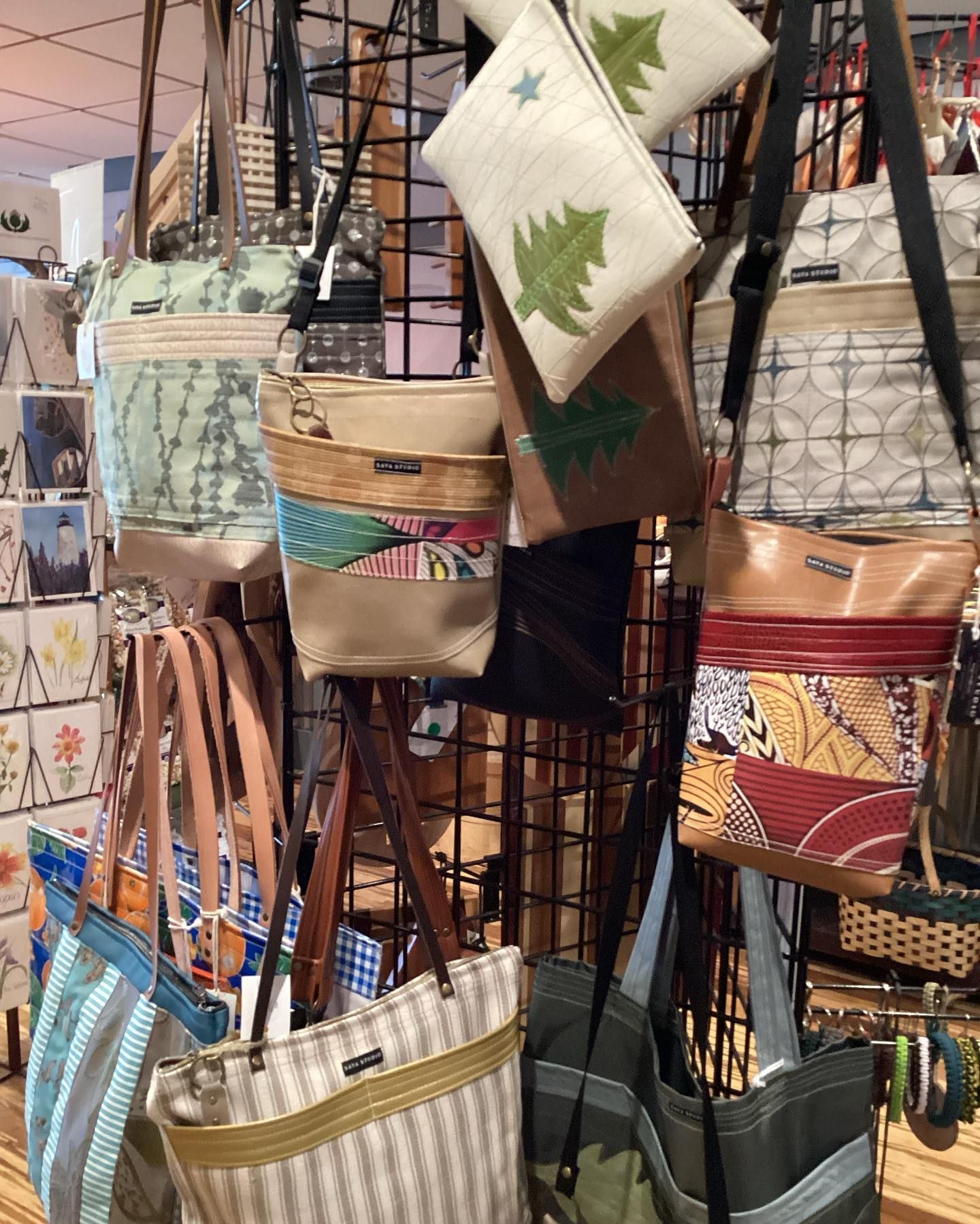 A bunch of bags are hanging on a rack in a store