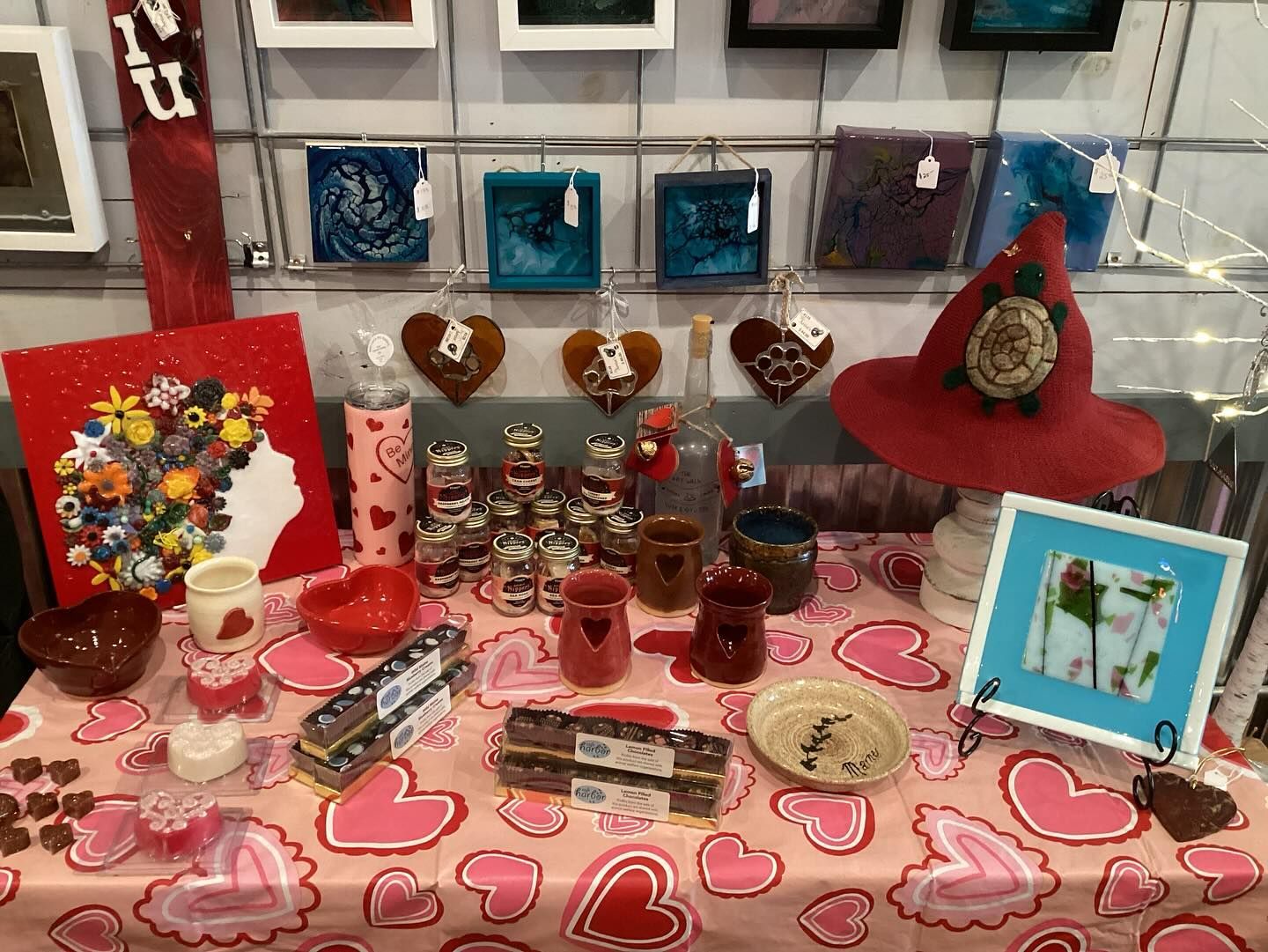 A table with a lot of hearts on it and a hat on it.