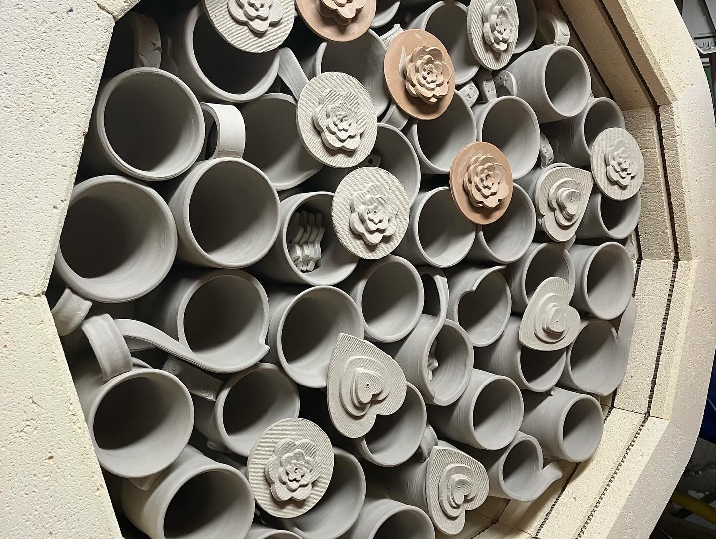 A bunch of mugs are stacked on top of each other