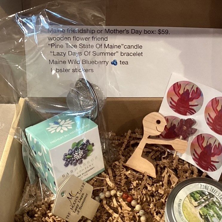 A box filled with a variety of items including a wooden flower friend.