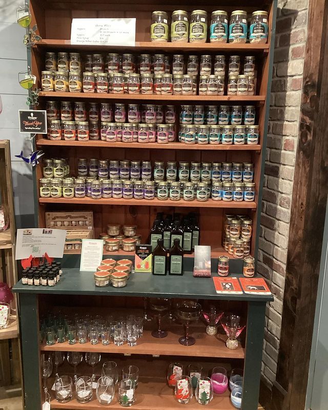 A wooden shelf filled with jars and bottles