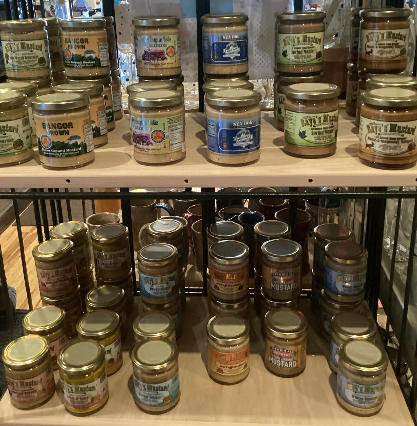 A shelf full of jars including one that says ginger