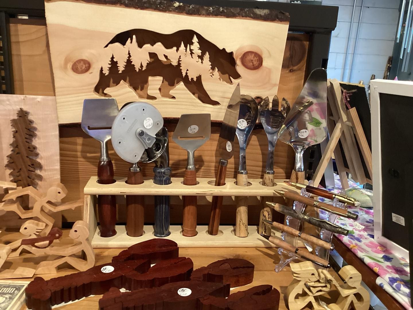 A display of wooden utensils with a picture of a bear on it