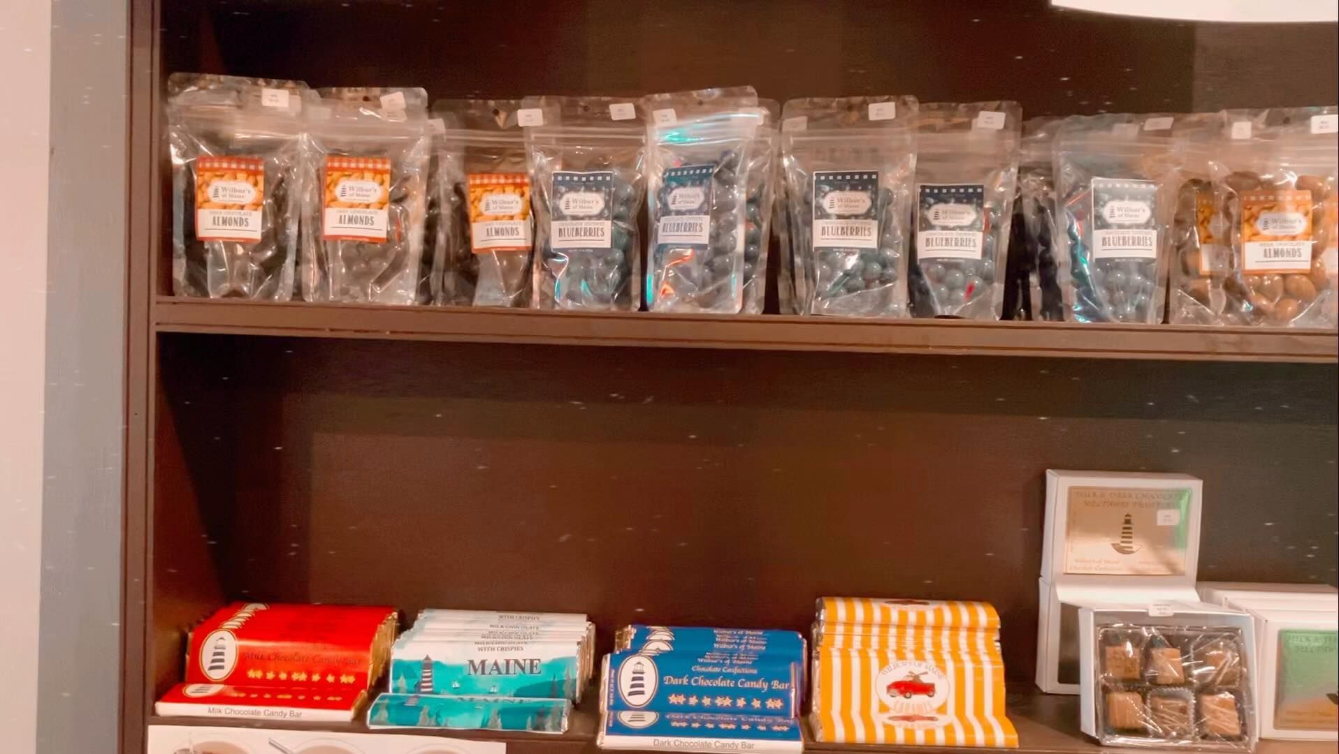 A shelf filled with bags of candy and other items.