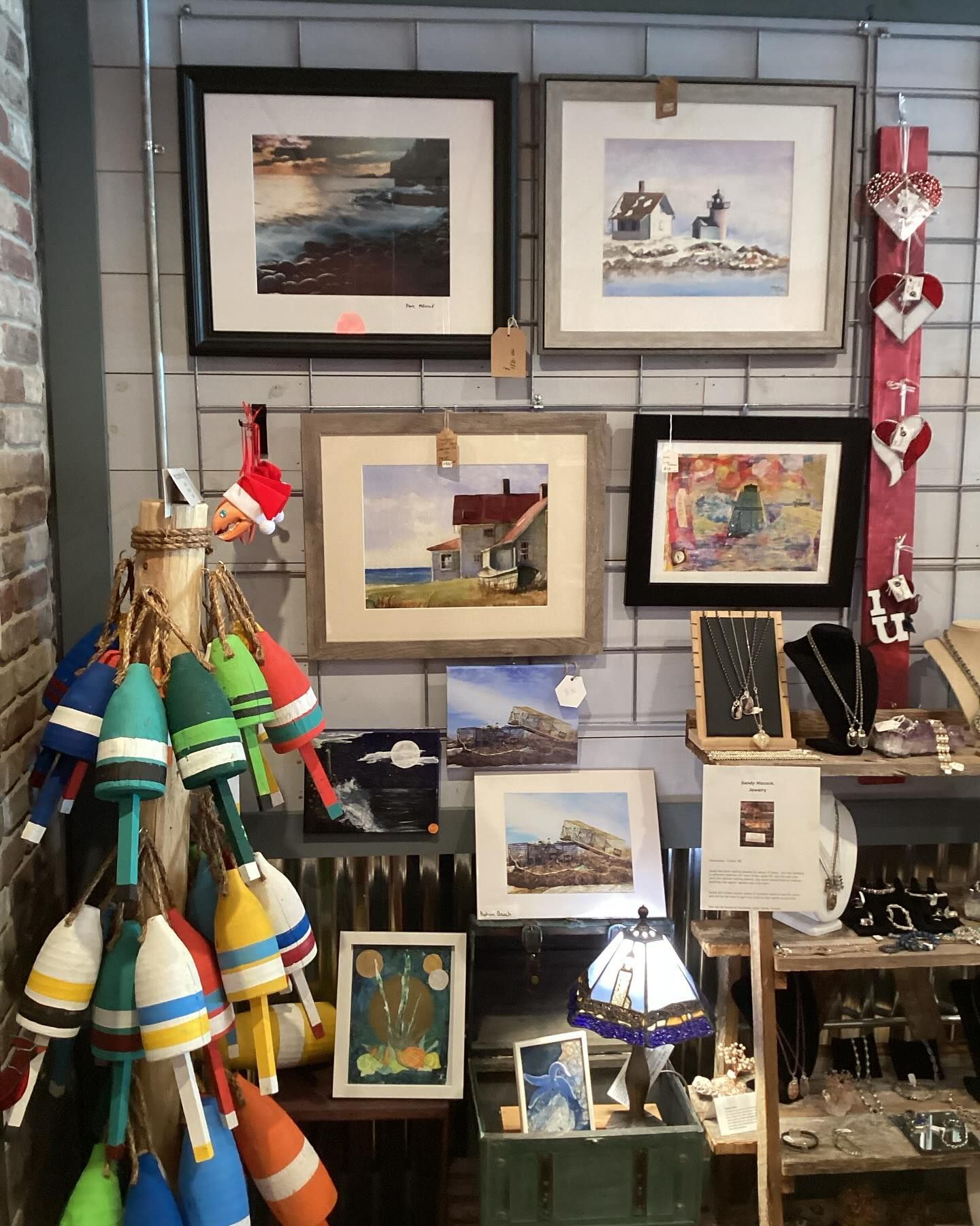 A display of paintings and buoys in a store