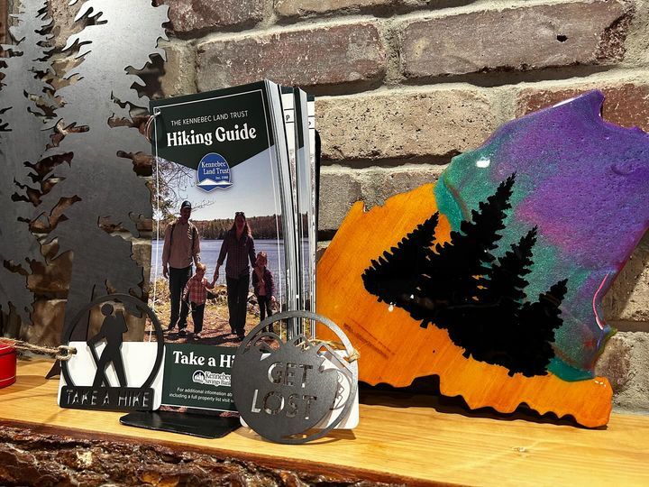 A book titled hiking guide is sitting on a wooden table