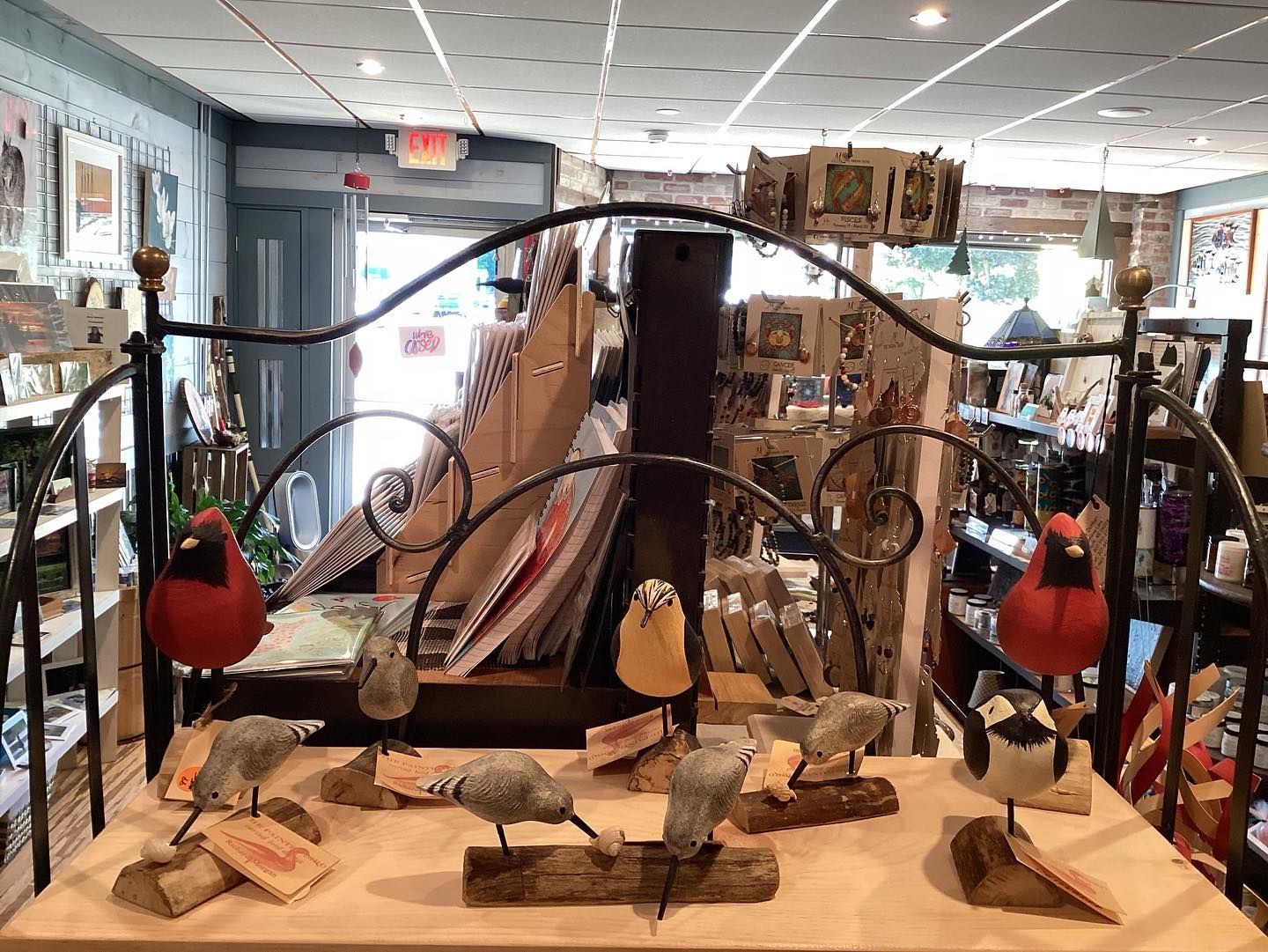 A table with a bunch of birds on it in a store.