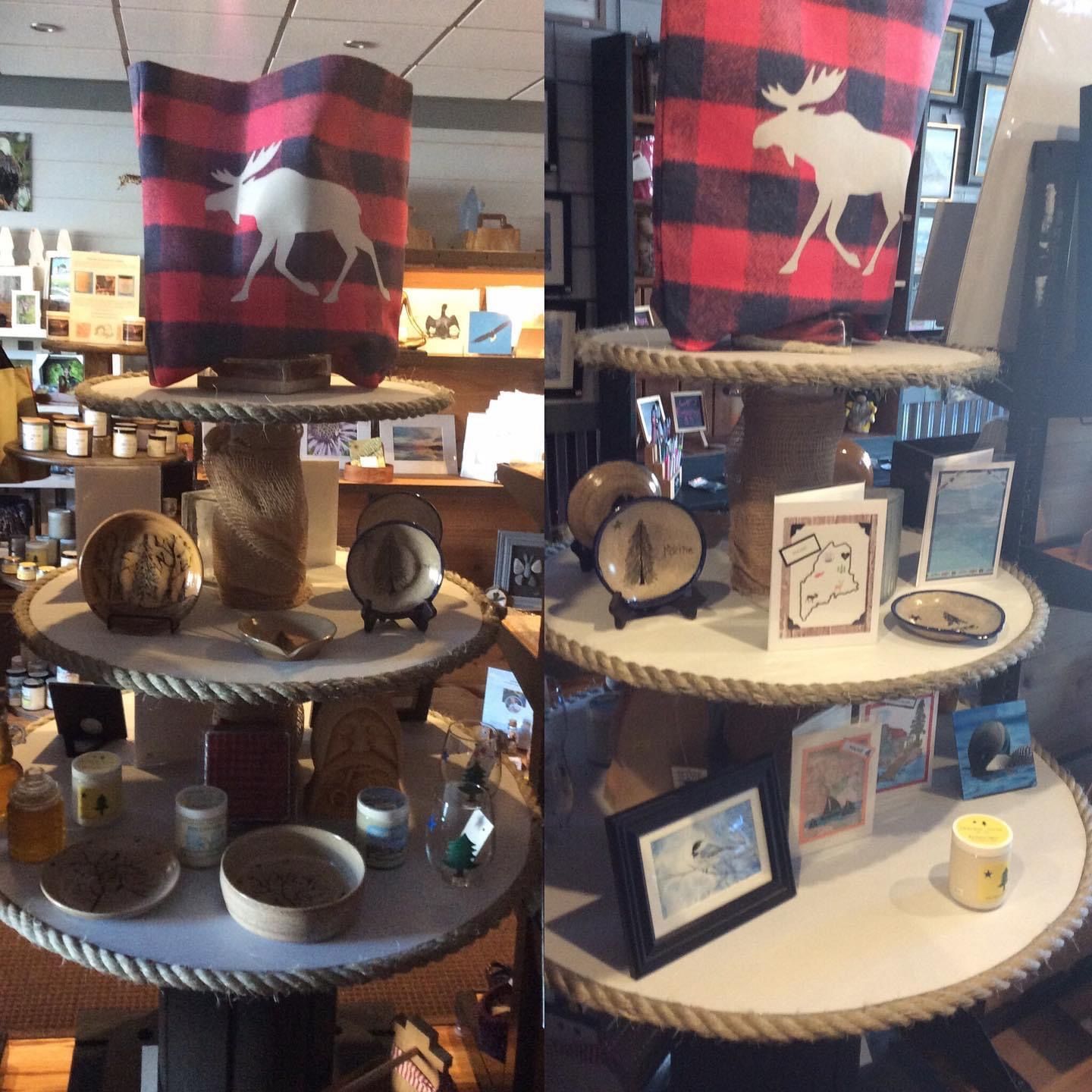 A display of various items including a plaid pillow with a moose on it