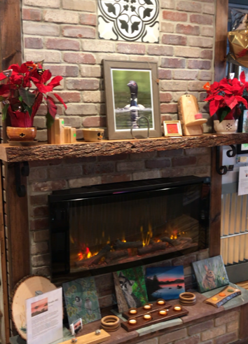 A fireplace with a picture of a duck on the mantle.