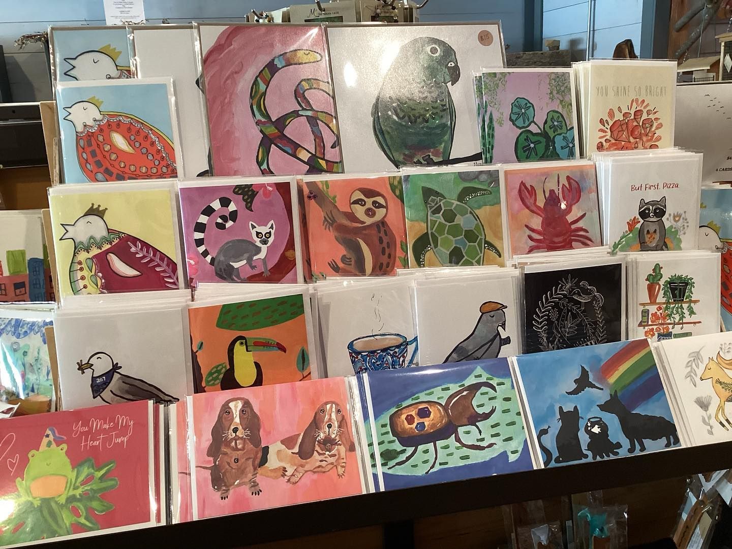 A display of greeting cards with animals and plants on them
