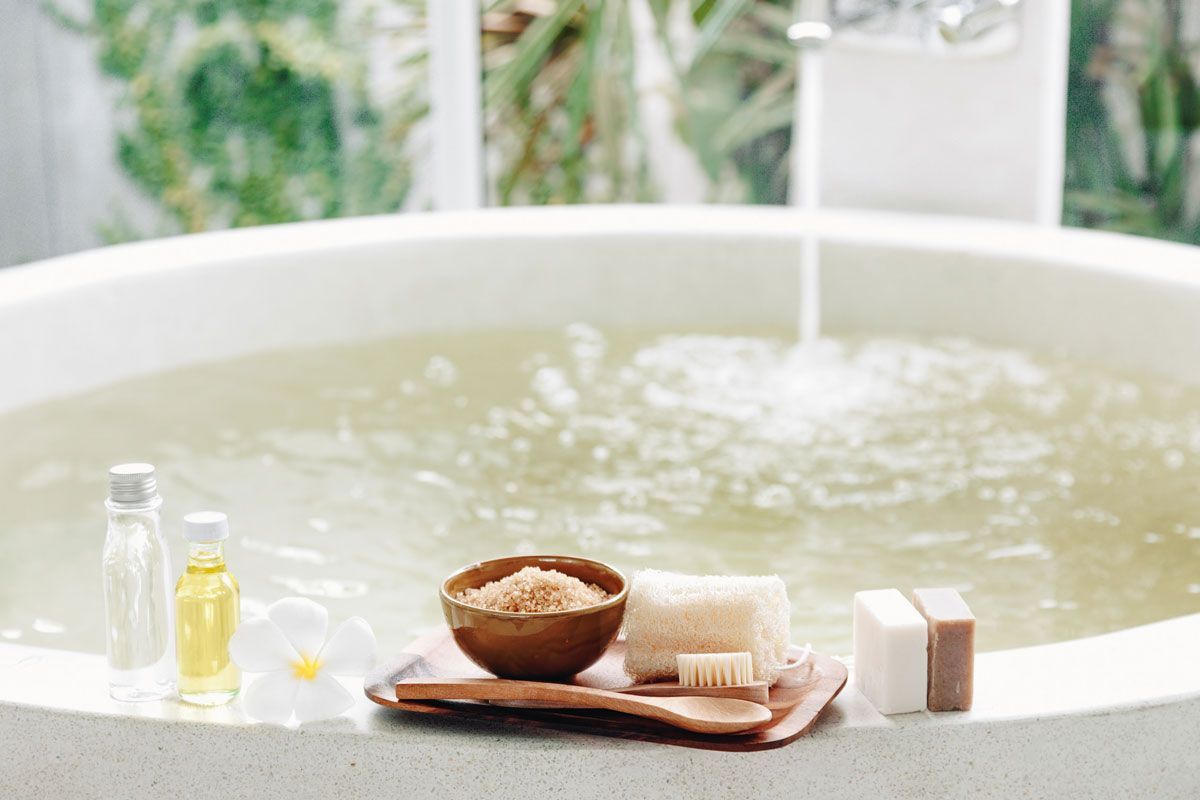 A bathtub filled with water and a bowl of sea salt