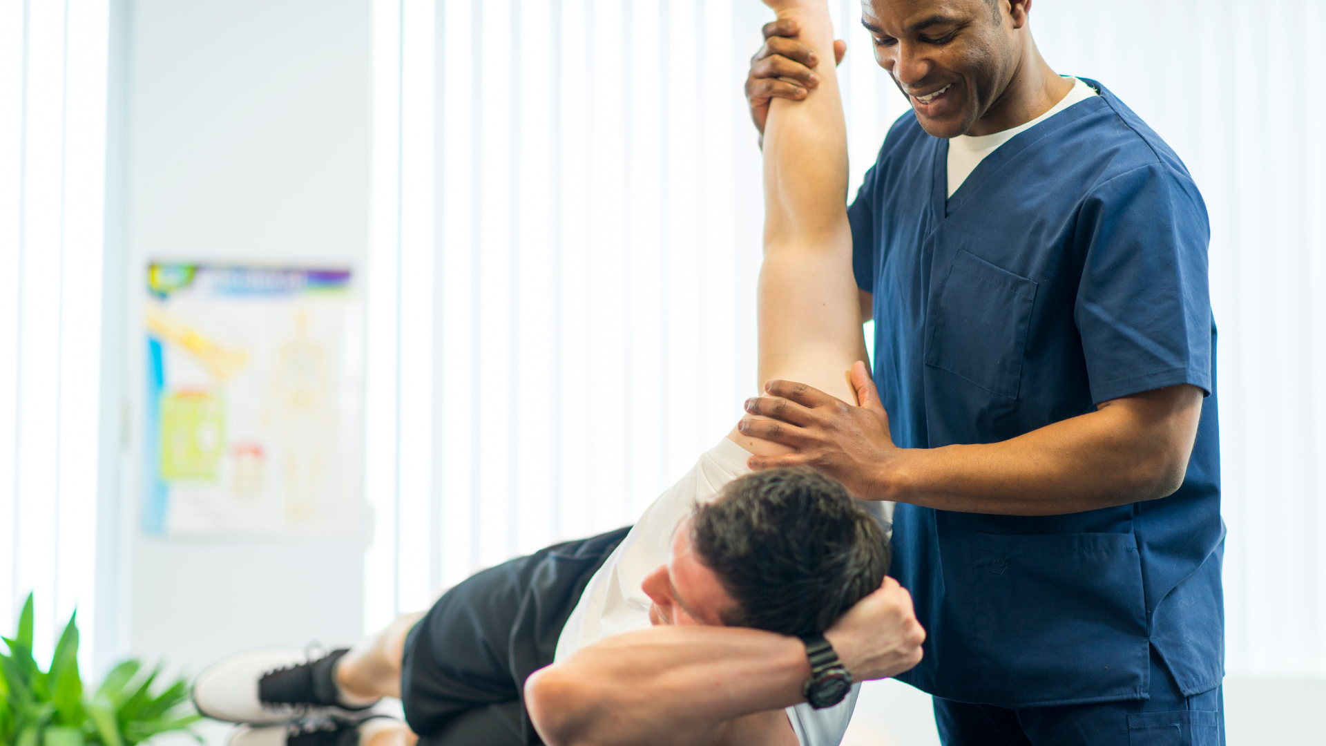 A man is getting a physical therapy treatment from a doctor.