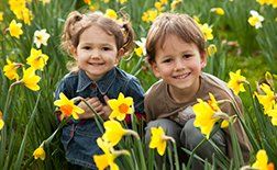 Children in flowers smiling