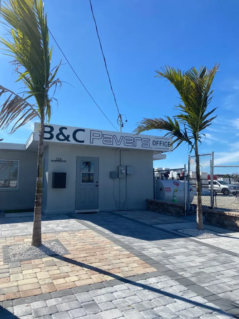 Concrete paver display area at contractor headquarters with palm trees