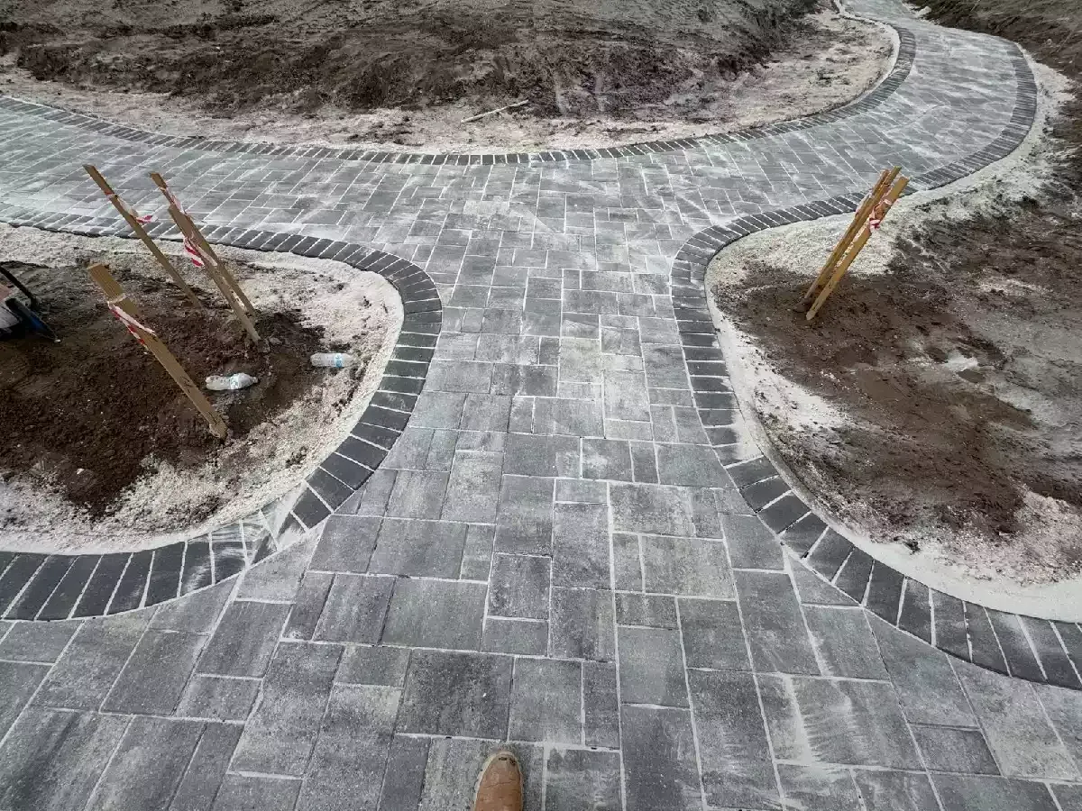 Gray concrete paver walkways with dark border