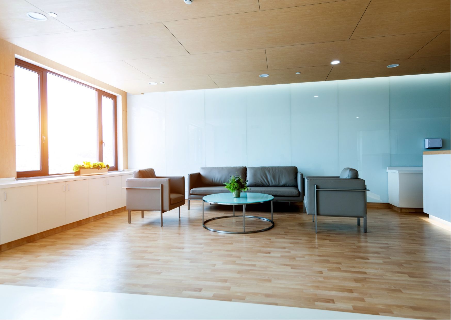 A waiting room decorated for christmas with a christmas tree and chairs.