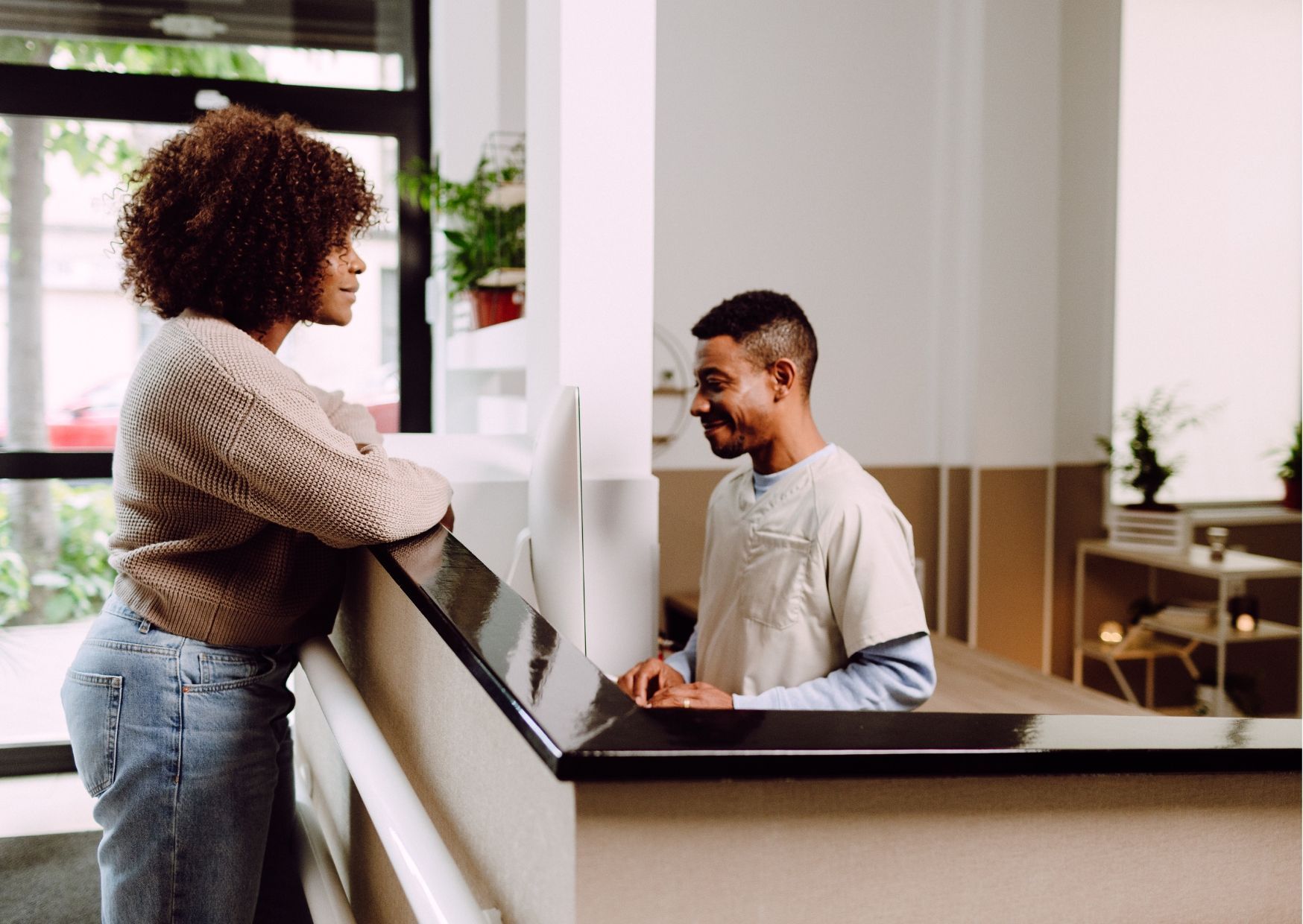 A group of people sitting under a red tent that says behavioral health center