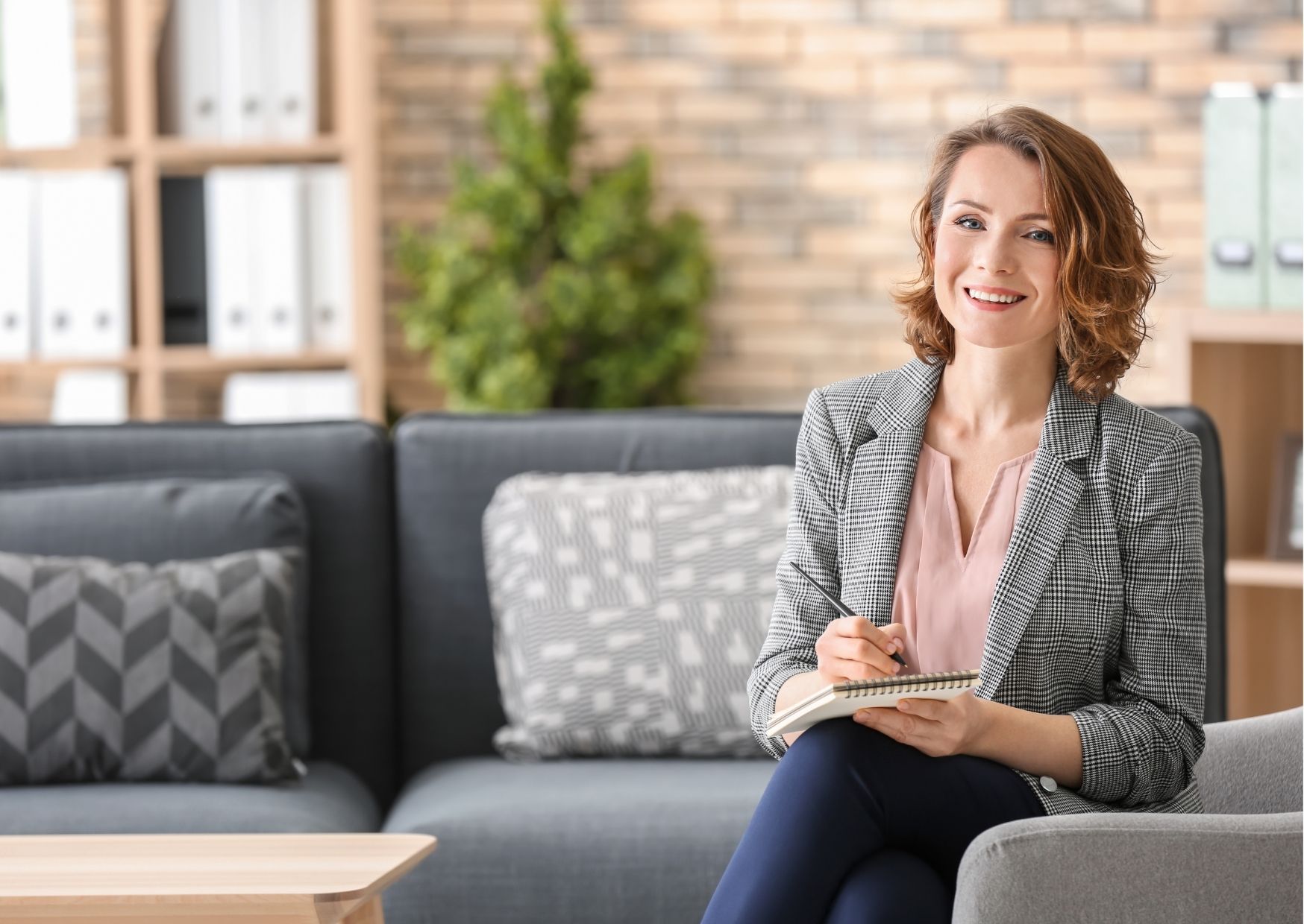 An elderly woman is laughing while talking to a doctor.