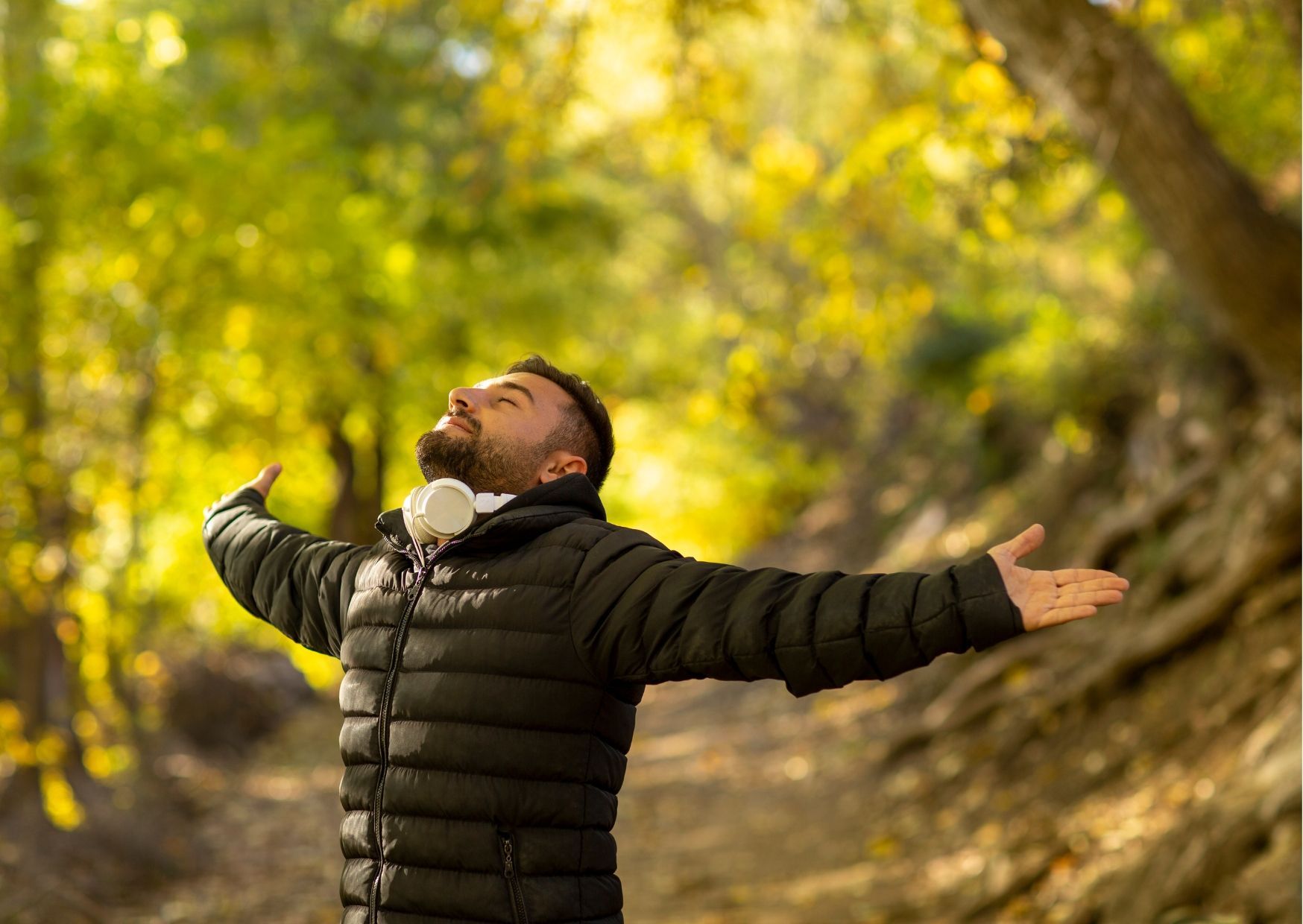A doctor is sitting at a table with a patient and writing on a clipboard.
