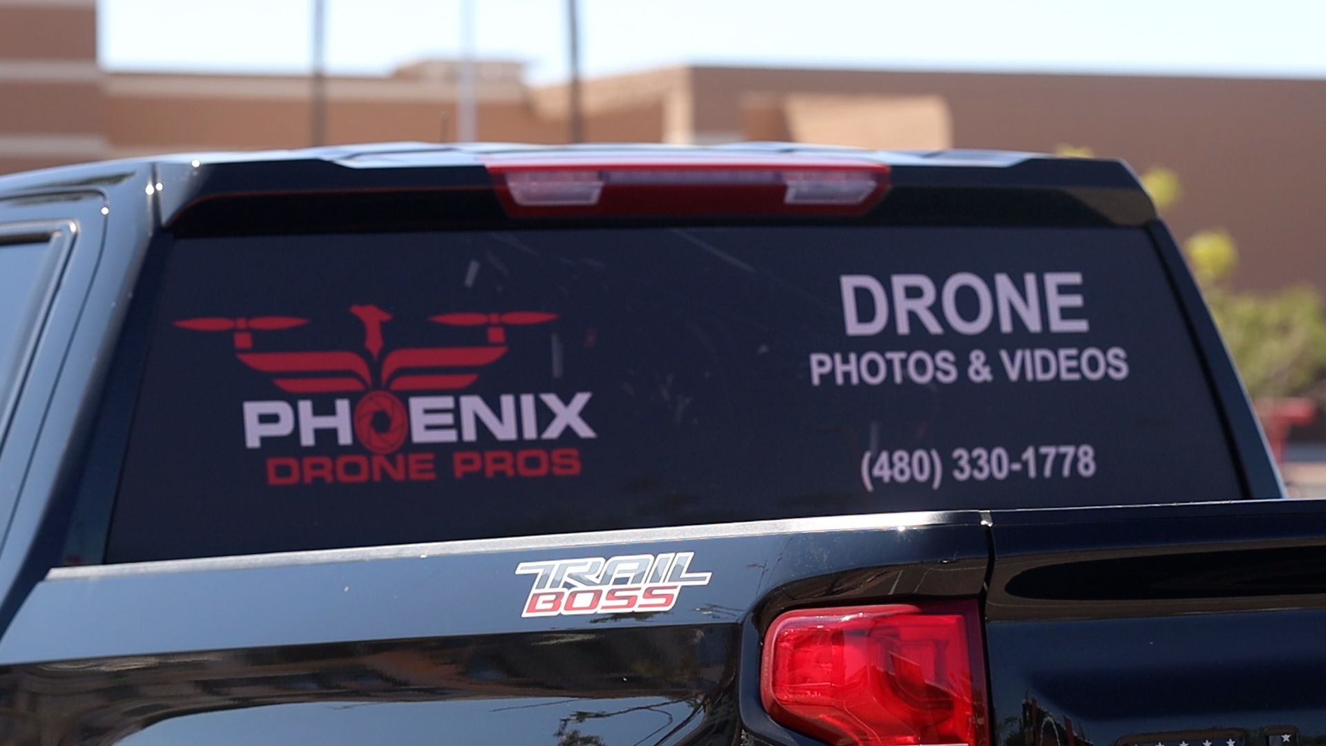 Photo by Phoenix Drone Pros, Robert Biggs, A black truck with a sticker on the back window that says drone photos and videos