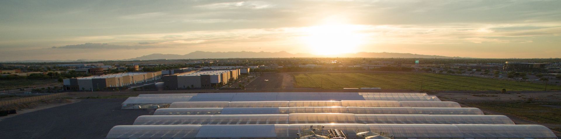 An aerial view of a greenhouse at sunset. Photo by Phoenix Drone Pros, Robert Biggs,