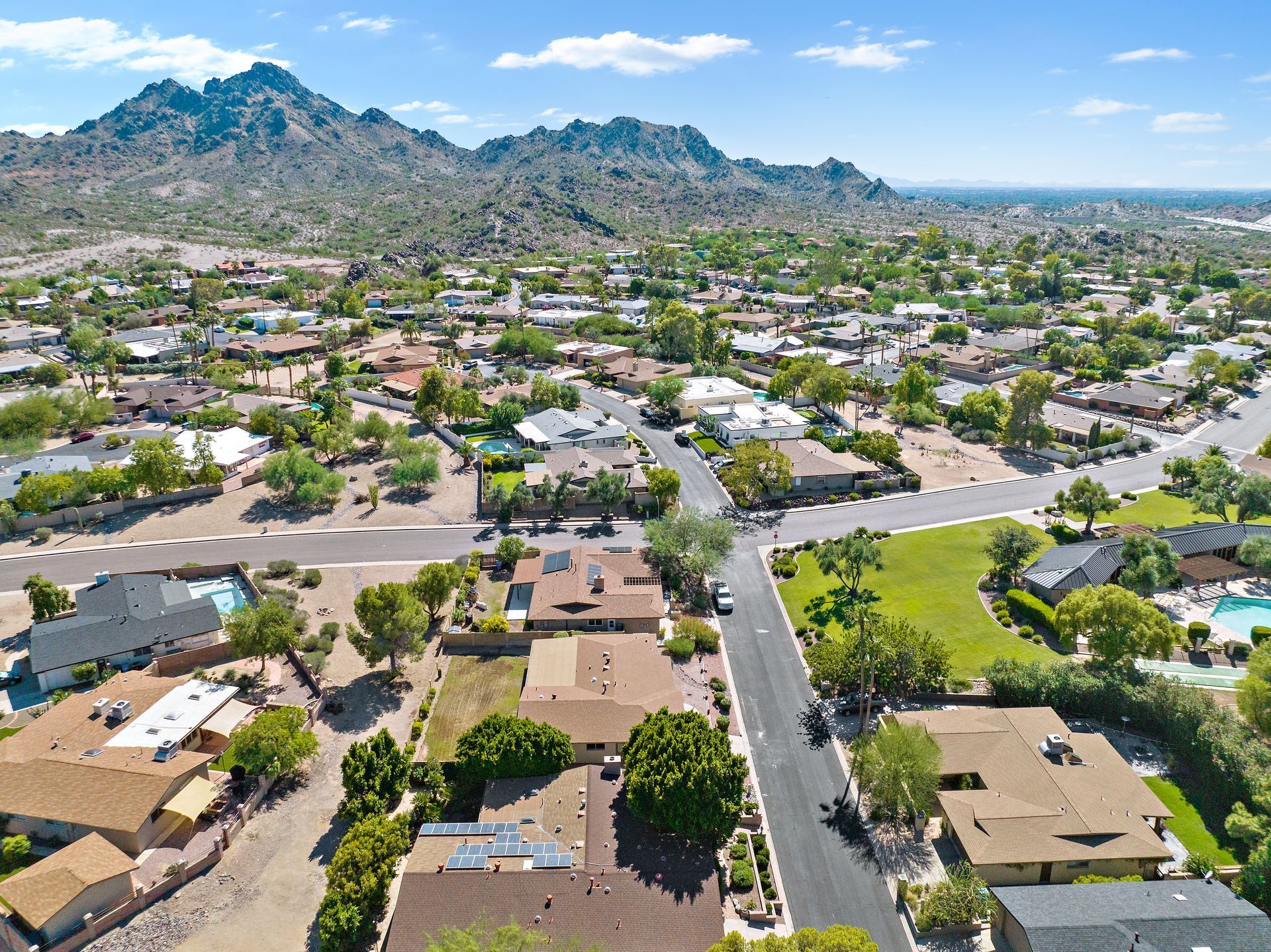 Photo by Phoenix Drone Pros, Robert Biggs, An aerial view of a residential area with mountains in the background