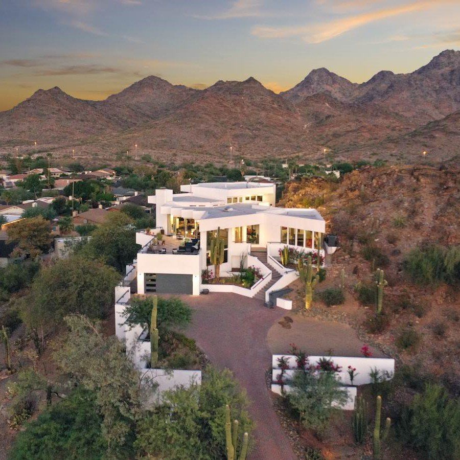 Photo by Phoenix Drone Pros, Robert Biggs, An aerial view of a large white house with mountains in the background