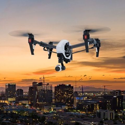 Photo by Phoenix Drone Pros, Robert Biggs, A drone is flying over a city at sunset