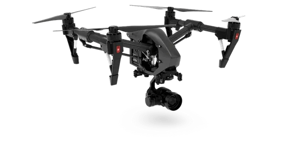 A black drone with a camera attached to it is flying in the air.