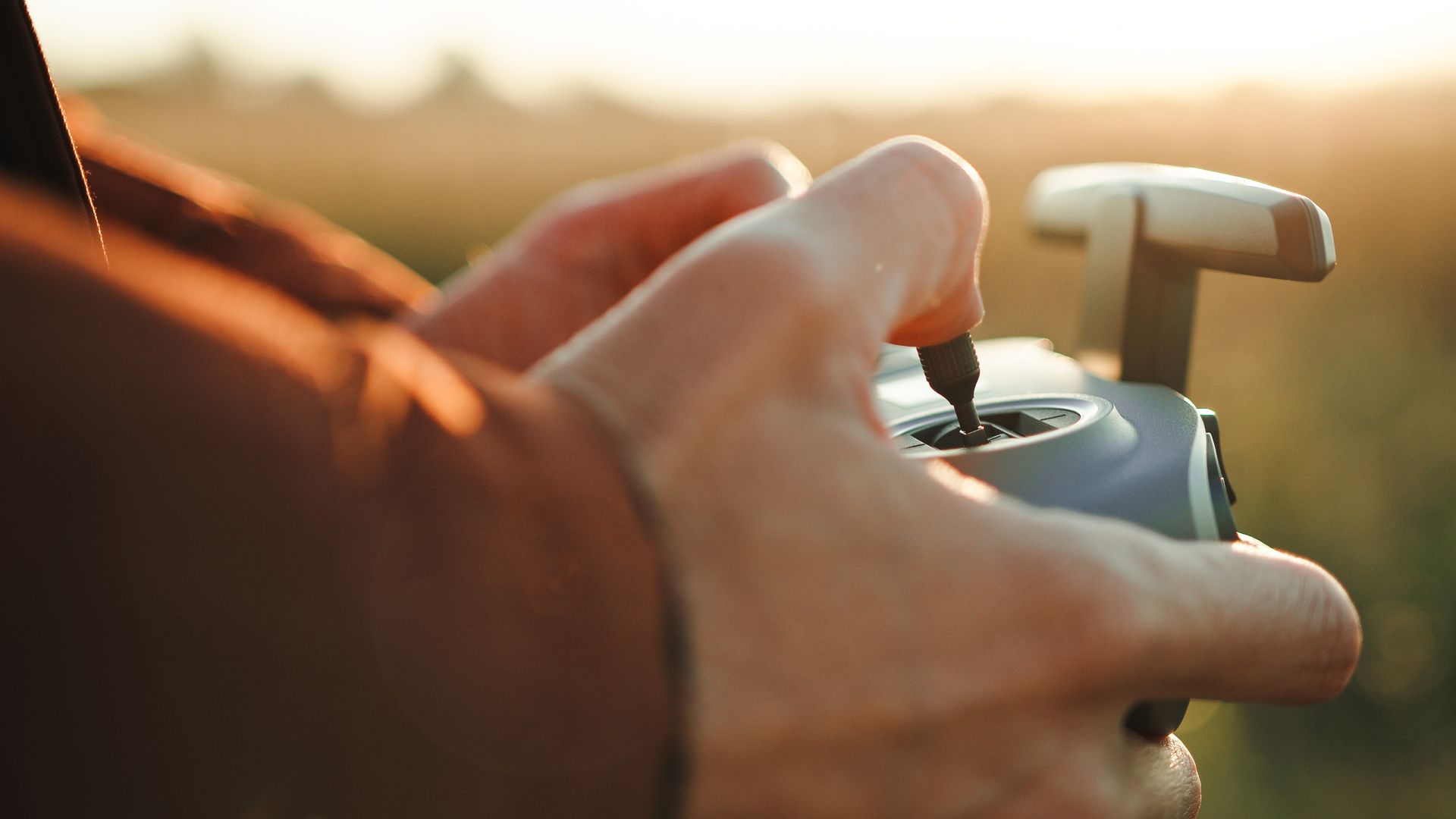 A person is holding a remote control in their hands.