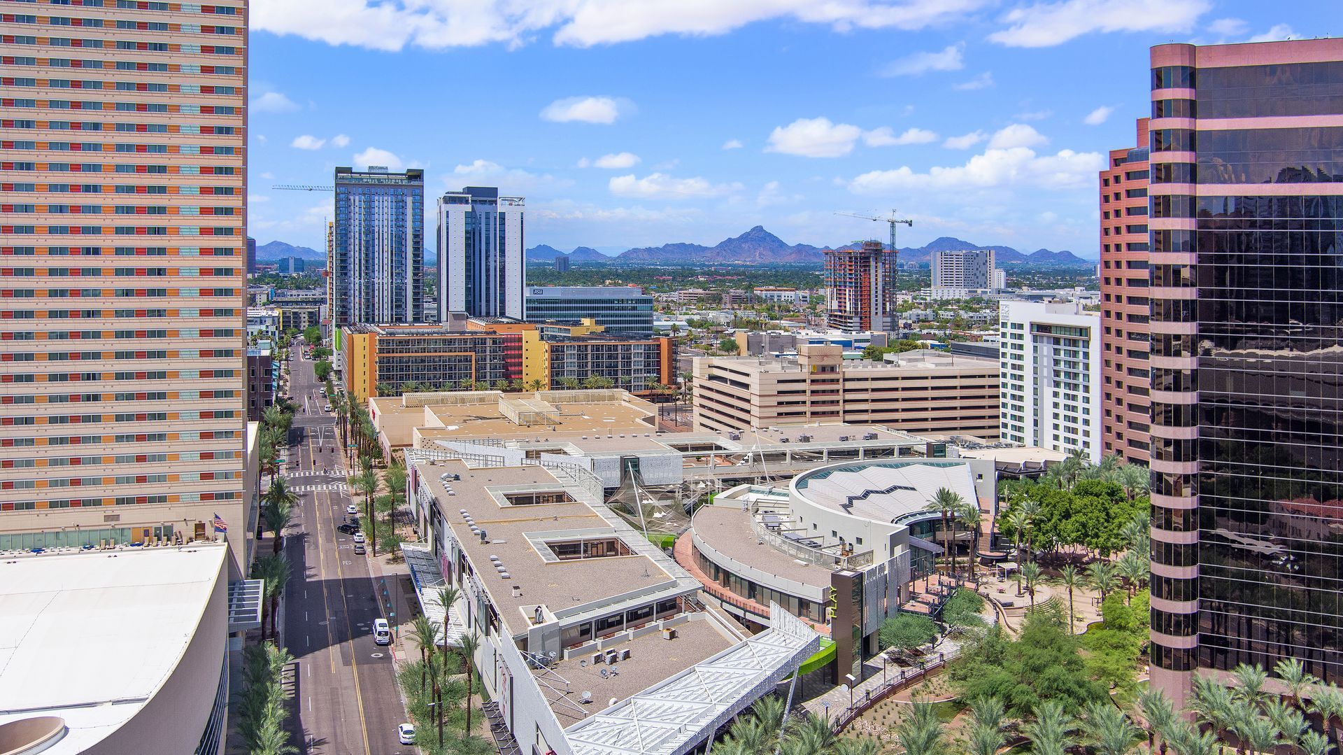 Photo by Phoenix Drone Pros, Robert Biggs, An aerial view of a city with a lot of buildings and trees.