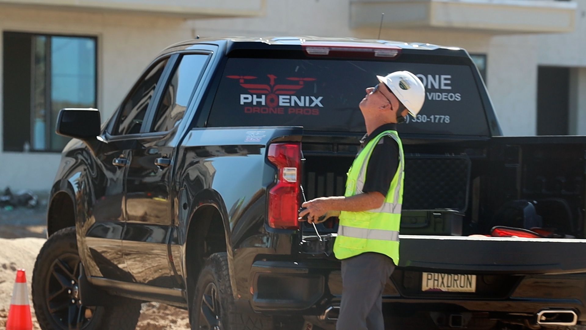 Photo by Phoenix Drone Pros, Robert Biggs, A man in a hard hat is standing in front of a truck.
