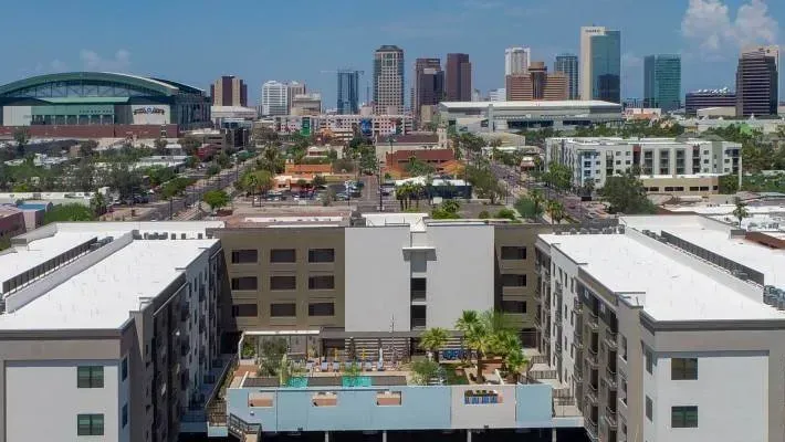 Photo by Phoenix Drone Pros, Robert Biggs, An aerial view of a city with a large building in the foreground