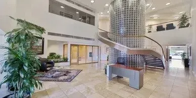Photo by Phoenix Drone Pros, Robert Biggs, A large lobby with a spiral staircase and a desk.
