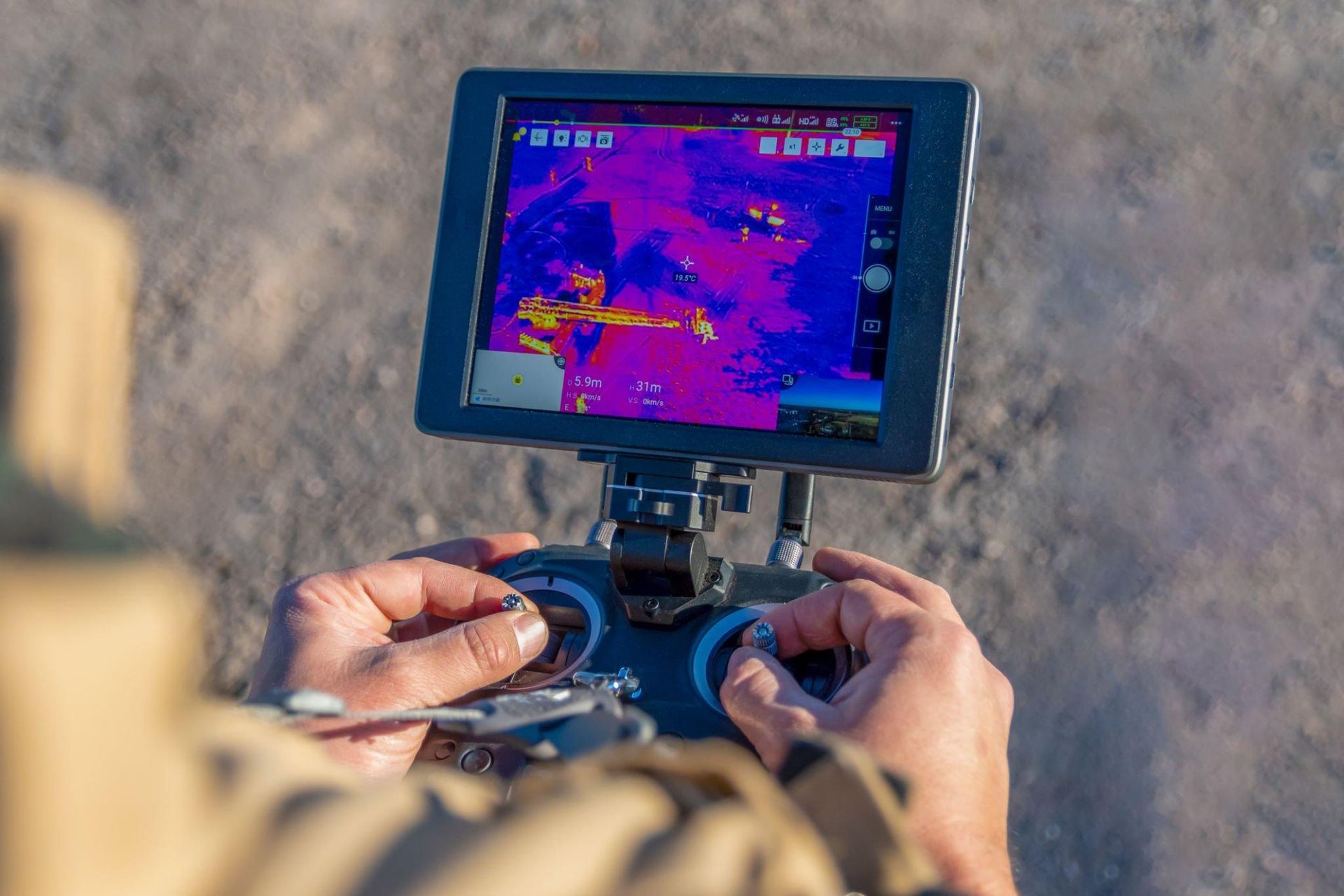 A person is using a remote control to control a drone.