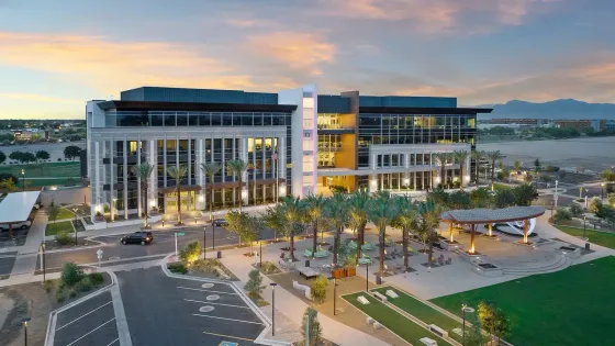 Photo by Phoenix Drone Pros, Robert Biggs, An aerial view of a large building with palm trees in front of it.