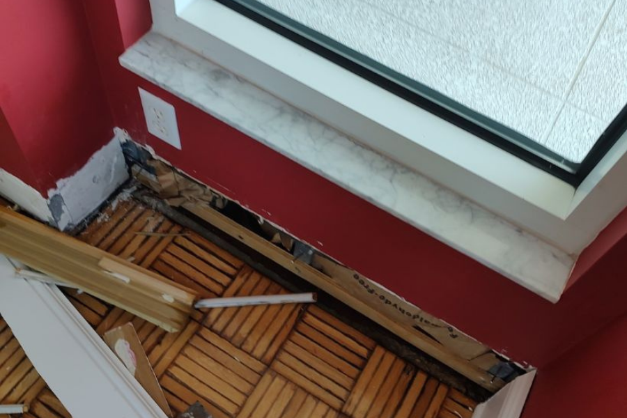 Hidden water damage revealed behind baseboards