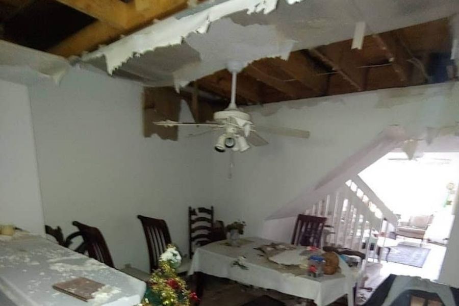 Extensive ceiling water damage showing residue throughout kitchen and dining areas