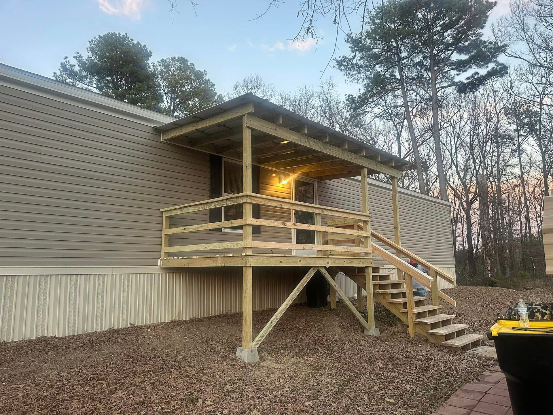 Mobile Home With a Wooden Deck and Stairs — Mayflower, AK — Riverbend Renovation and Repair