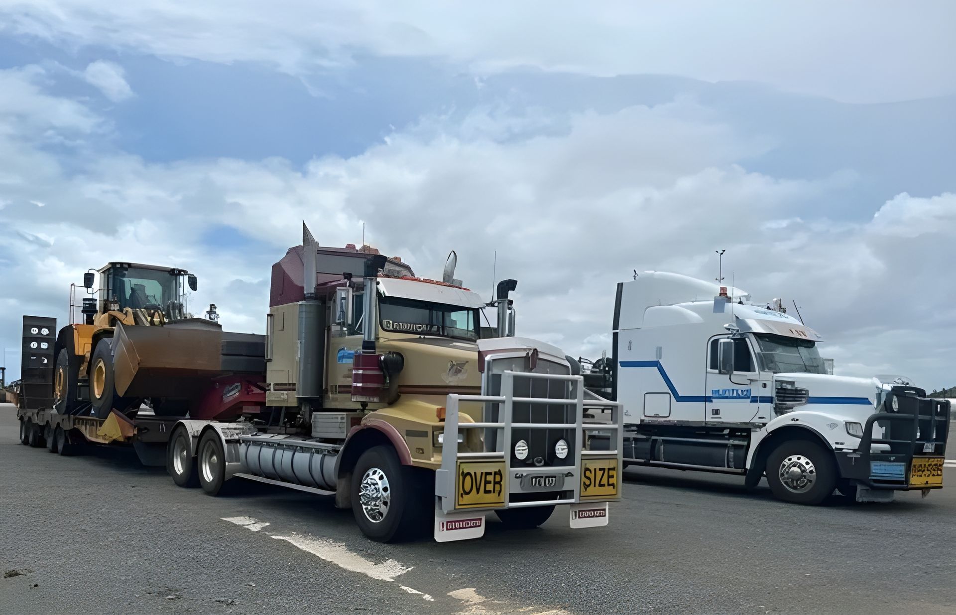 Two Semi-trucks, One Hauling Construction Equipment — Huntlys Heavy Equipment in Gracemere, QLD
